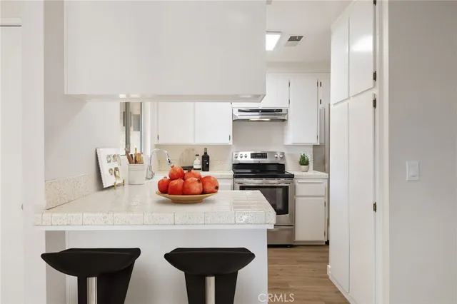 a kitchen with stainless steel appliances a sink and cabinets
