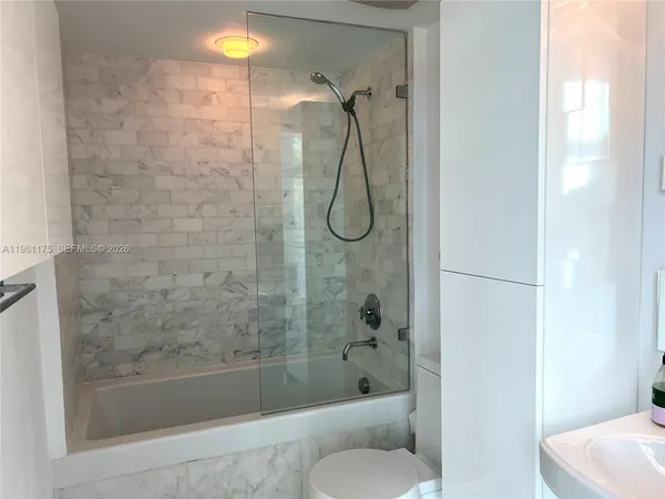 a bathroom with a shower and bathtub