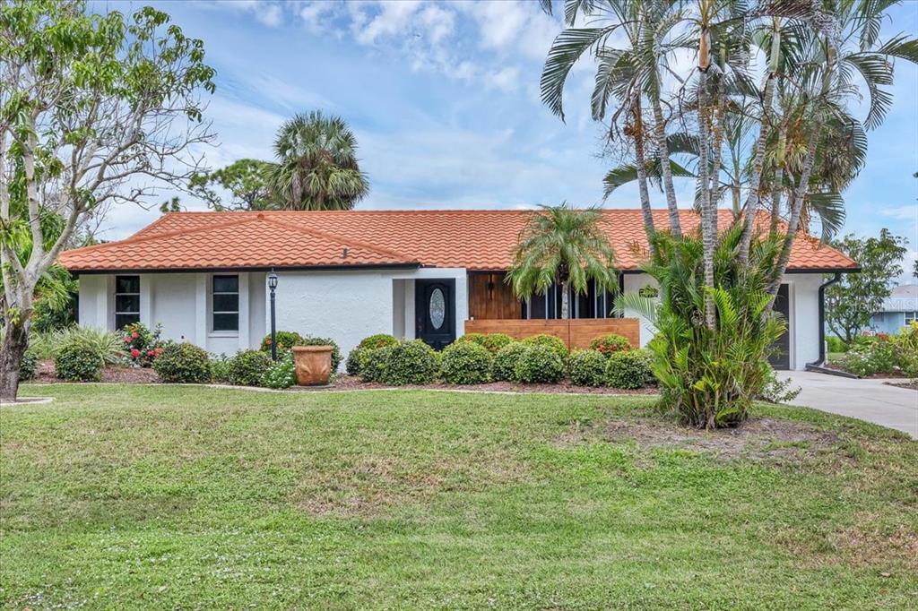 4696 Pompano Street Placida, FL 33946 - Photo 23 of 23 a front view of a house with garden