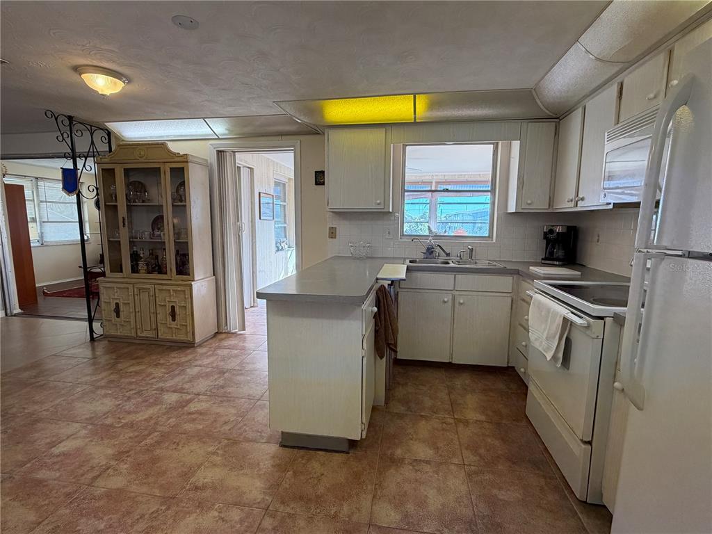 3914 Carioca Road Holiday, FL 34691 - Photo 11 of 23 a kitchen with a sink cabinets and appliances