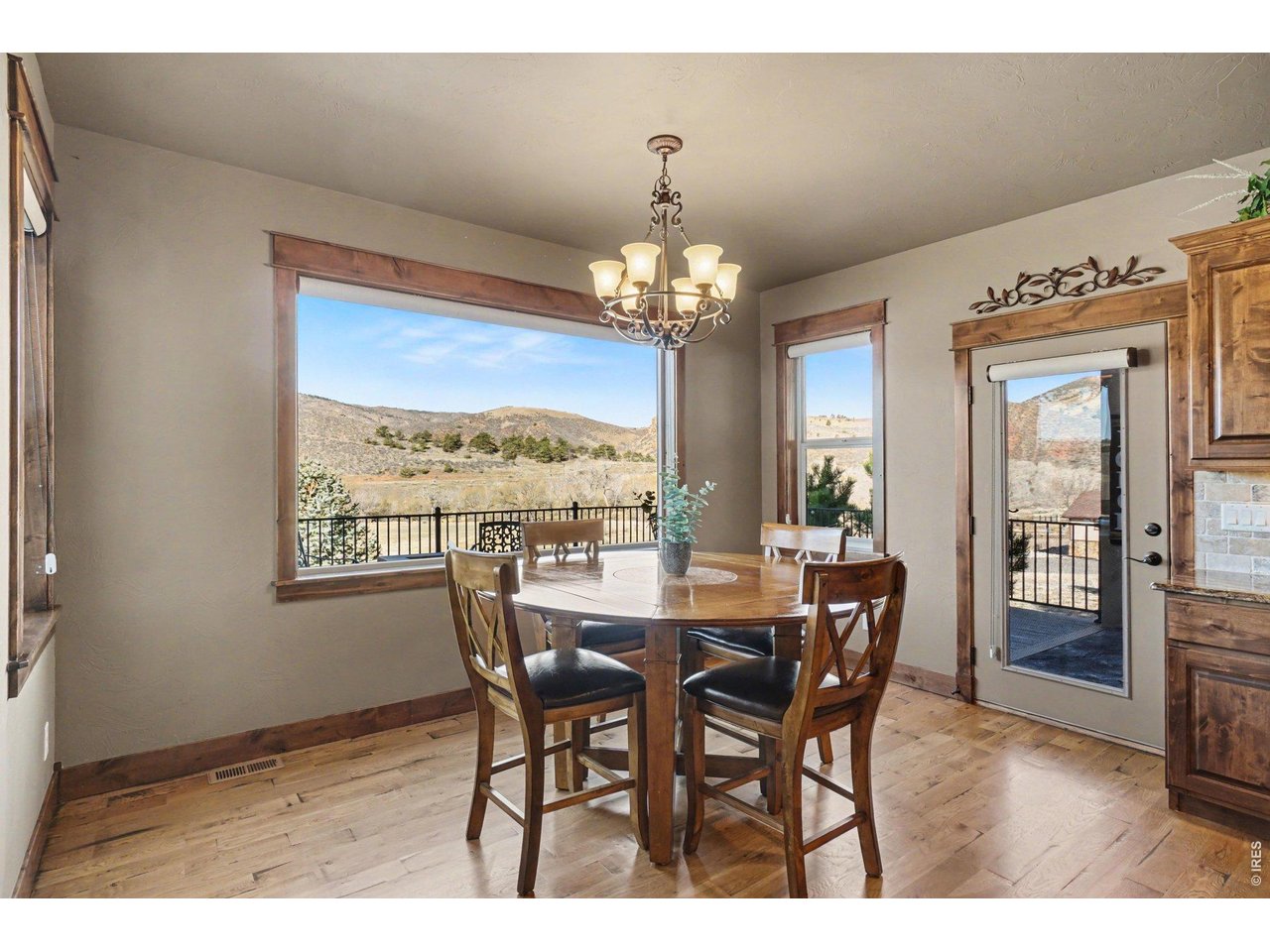 10723 Buckhorn Ridge Way Loveland, CO 80538 - Photo 13 of 50 a view of a dining room with furniture wooden floor and chandelier