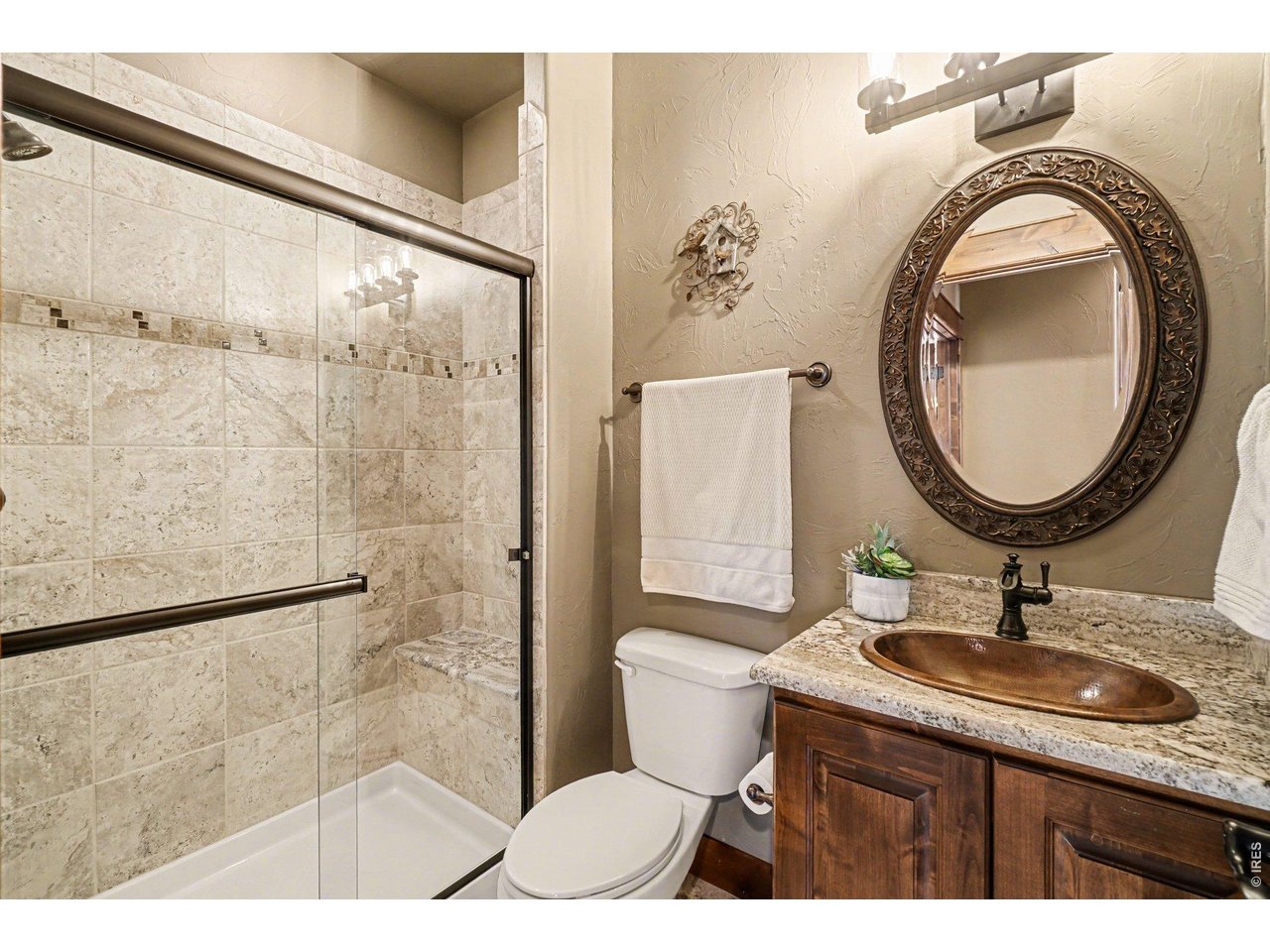 10723 Buckhorn Ridge Way Loveland, CO 80538 - Photo 17 of 50 a bathroom with a sink a toilet and a mirror