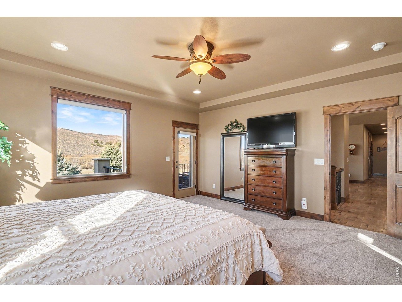 10723 Buckhorn Ridge Way Loveland, CO 80538 - Photo 20 of 50 a bedroom with a bed and a flat screen tv