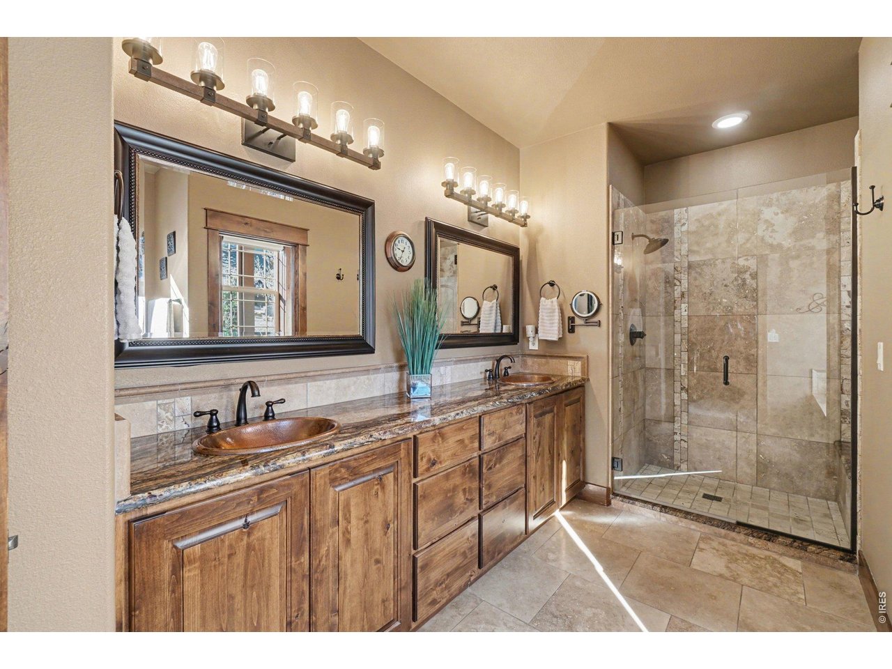 10723 Buckhorn Ridge Way Loveland, CO 80538 - Photo 21 of 50 a bathroom with a sink a shower a mirror and a shower