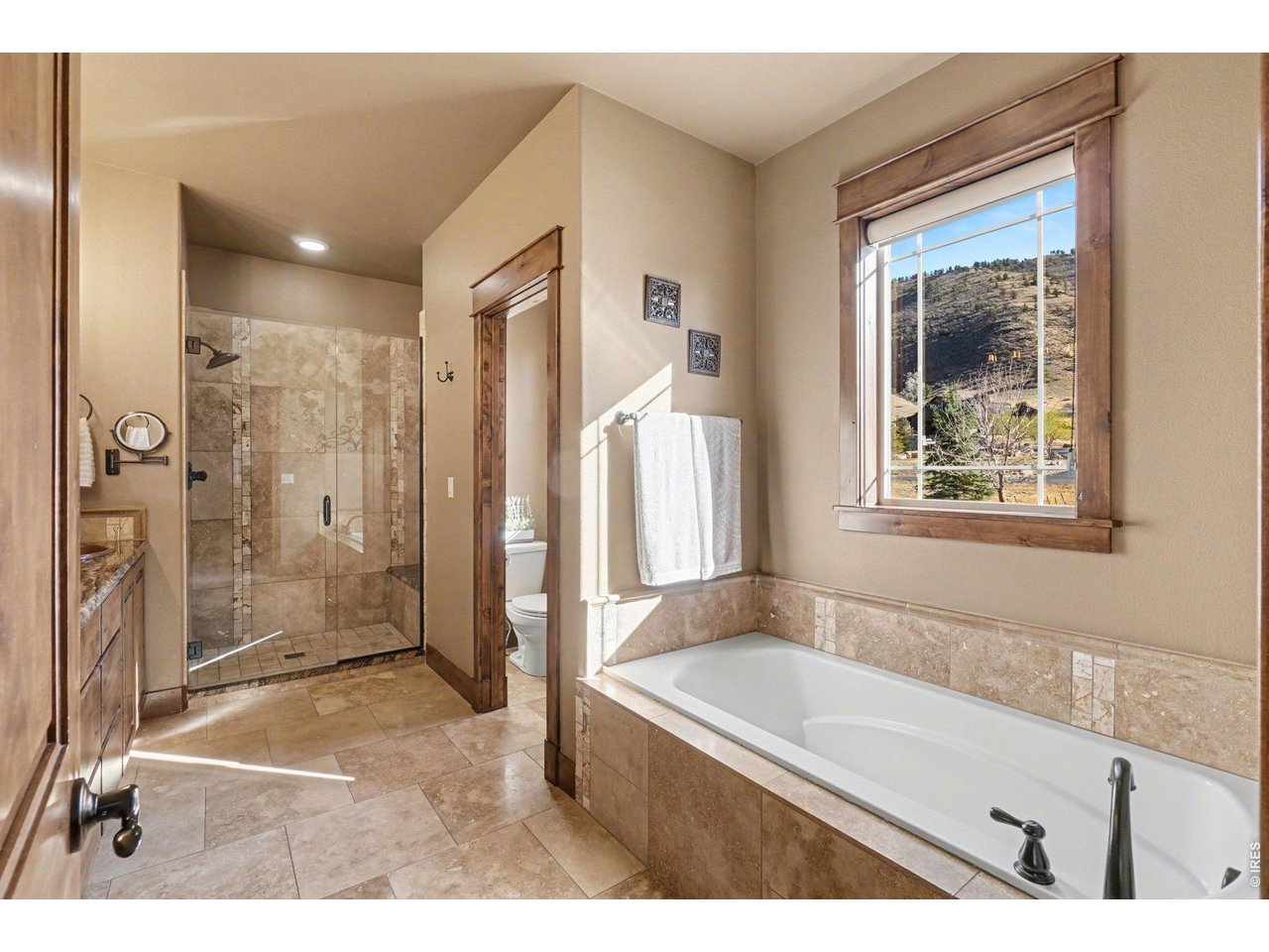 10723 Buckhorn Ridge Way Loveland, CO 80538 - Photo 22 of 50 a bathroom with a tub a sink and a shower