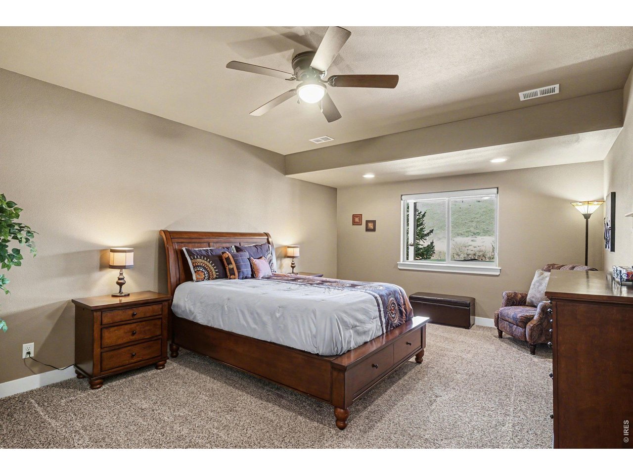 10723 Buckhorn Ridge Way Loveland, CO 80538 - Photo 33 of 50 a bedroom with a bed window and couch