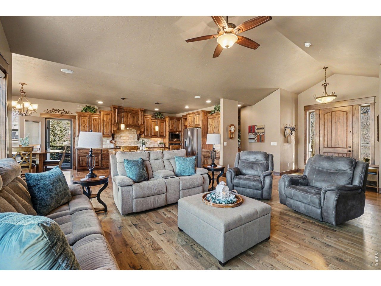 10723 Buckhorn Ridge Way Loveland, CO 80538 - Photo 7 of 50 a living room with furniture kitchen view and a chandelier