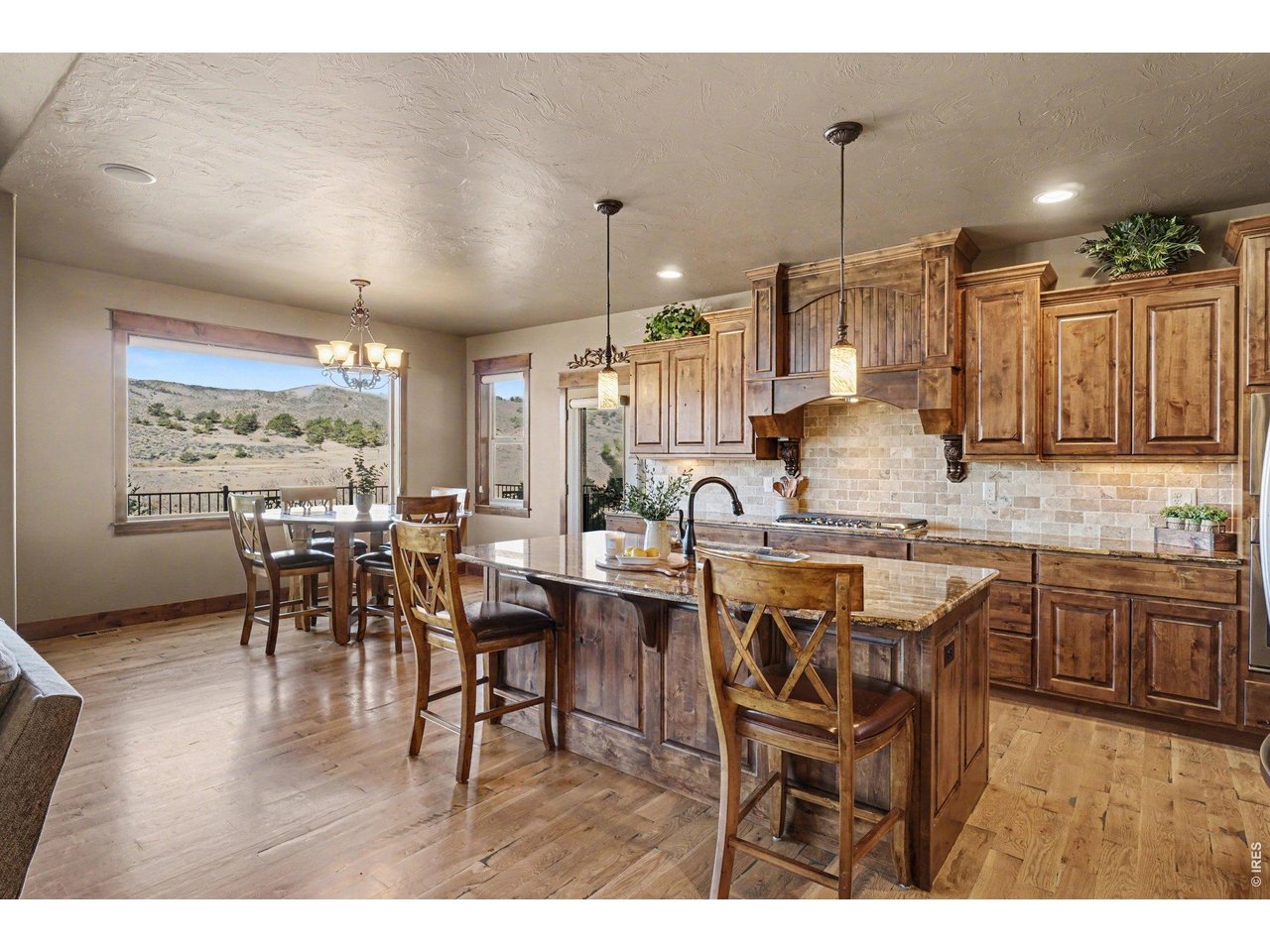 10723 Buckhorn Ridge Way Loveland, CO 80538 - Photo 9 of 50 a dining hall with stainless steel appliances kitchen island a table and chairs