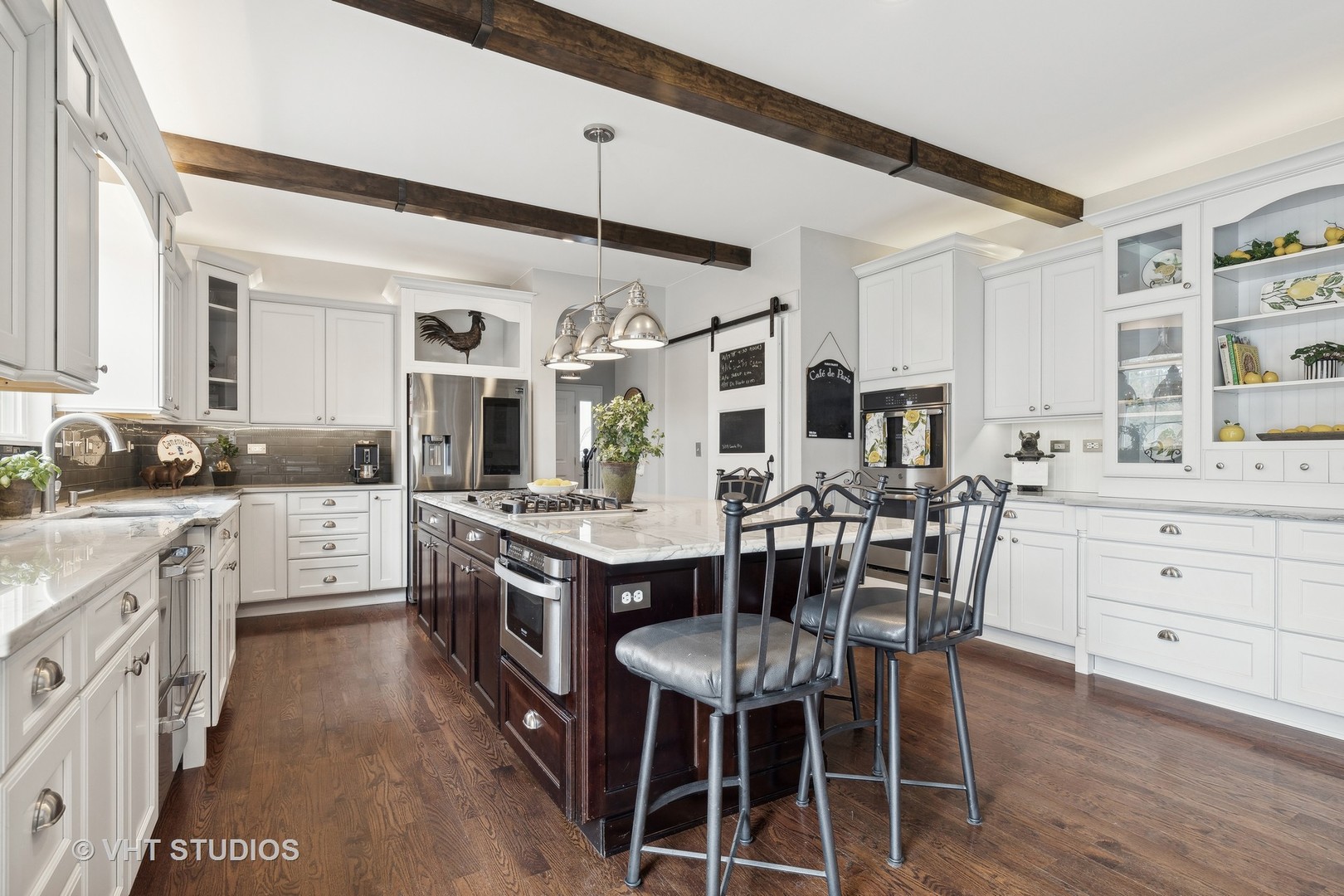 303 Saddle Lane Fox River Grove, IL 60021 - Photo 30 of 70 a kitchen with stainless steel appliances kitchen island granite countertop a table chairs sink and cabinets
