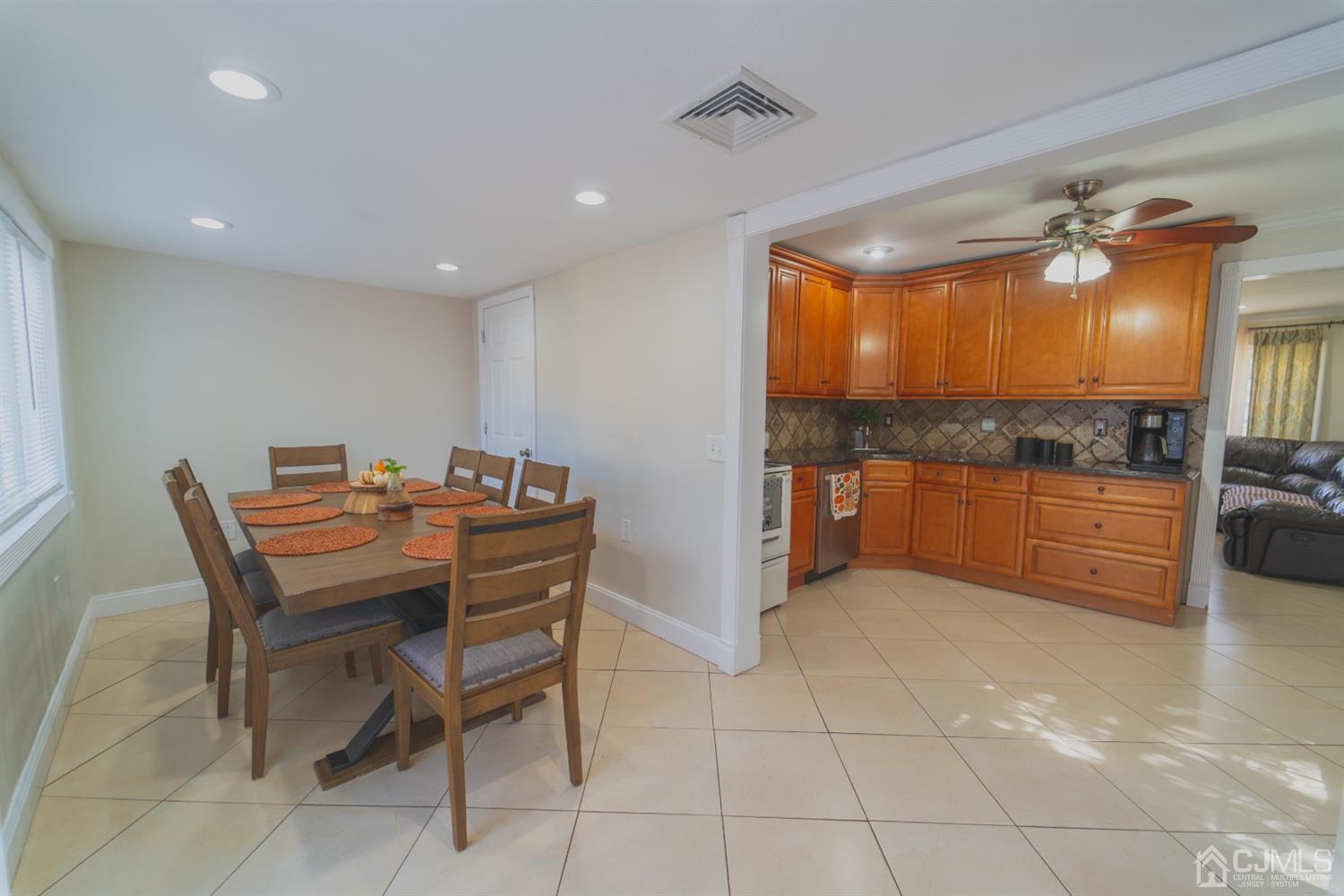 22 Richmond Road Edison, NJ 08817 - Photo 2 of 19 a dining room filled a chandelier and kitchen view