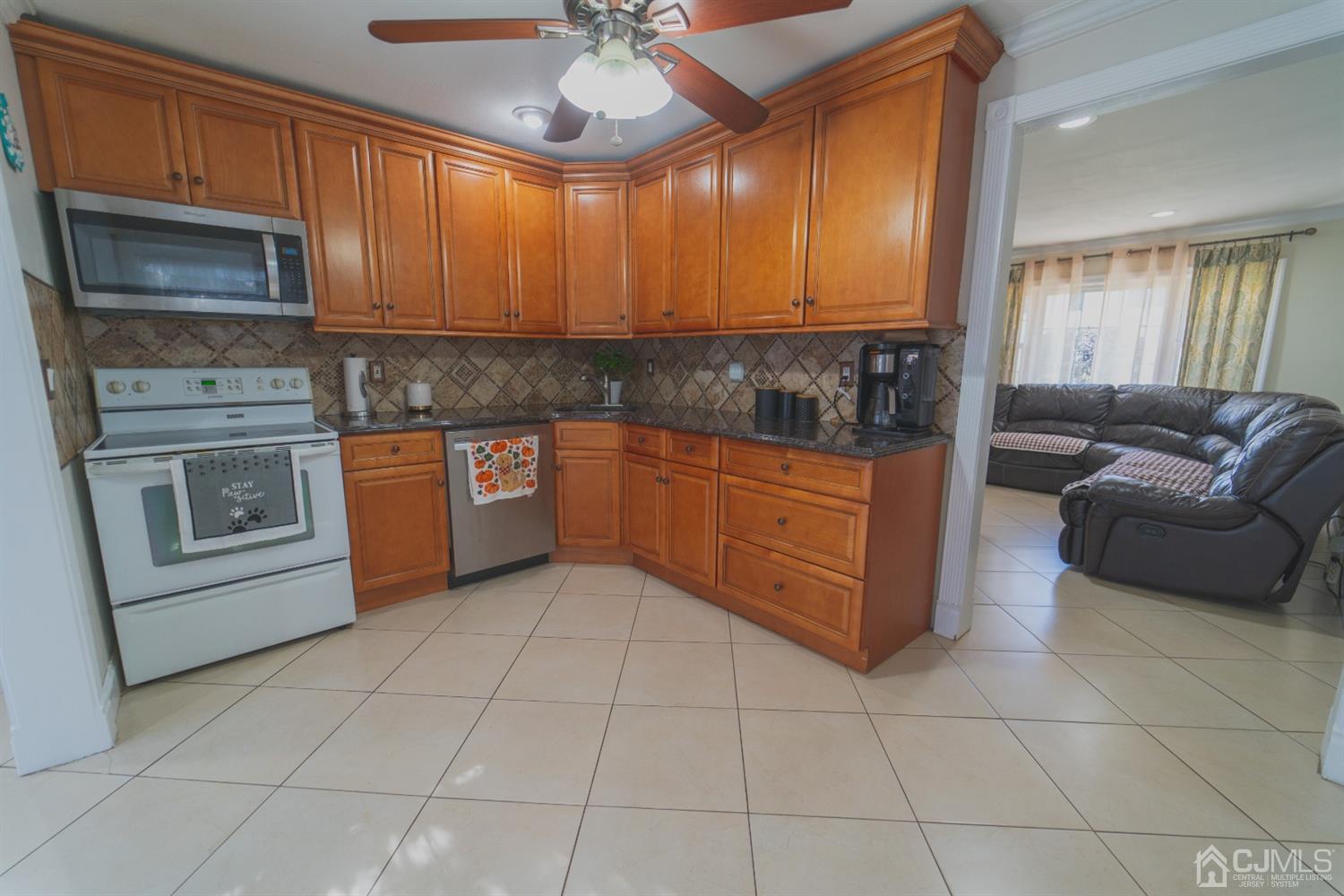 22 Richmond Road Edison, NJ 08817 - Photo 11 of 19 a kitchen with stainless steel appliances granite countertop a stove a sink and a microwave