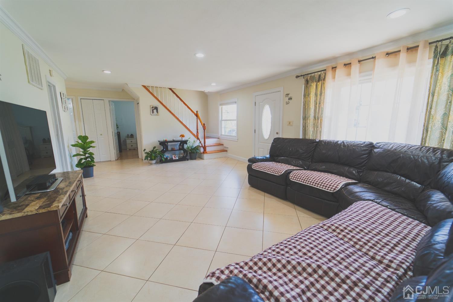 22 Richmond Road Edison, NJ 08817 - Photo 16 of 19 a living room with furniture and a flat screen tv
