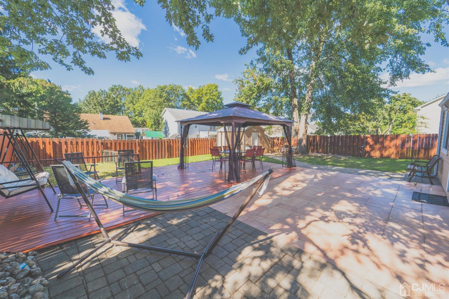 22 Richmond Road Edison, NJ 08817 - Photo 18 of 19 a view of a patio with a table chairs and a fire pit