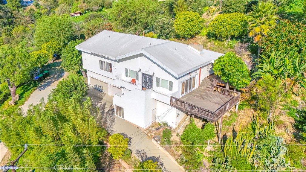 an aerial view of a house with a yard table and chairs