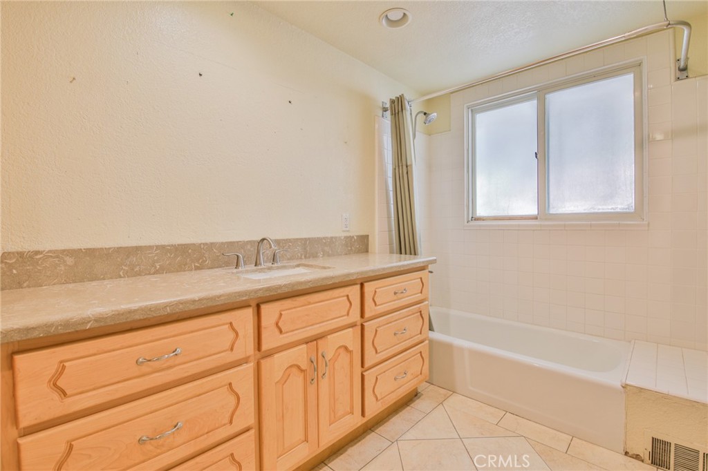 1707 Nabal Road La Habra Heights, CA 90631 - Photo 42 of 64 a bathroom with a granite countertop sink a mirror and a bathtub