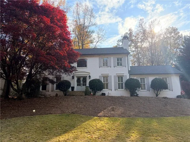 a view of house with swimming pool