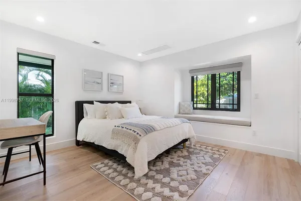 a bedroom with a bed and a window