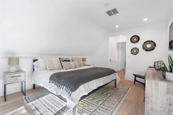 a bedroom with a bed and a lamp