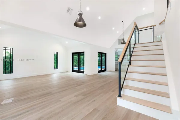 a view of entryway and hall with wooden floor