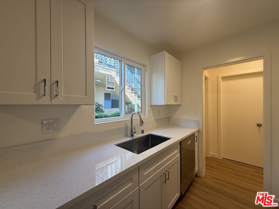 1314 10th Street, Unit A Santa Monica, CA 90401 - Photo 17 of 53 a kitchen with a sink and cabinets