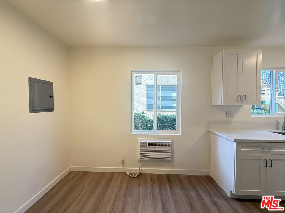 1314 10th Street, Unit A Santa Monica, CA 90401 - Photo 22 of 53 an empty room with a window and wooden floor