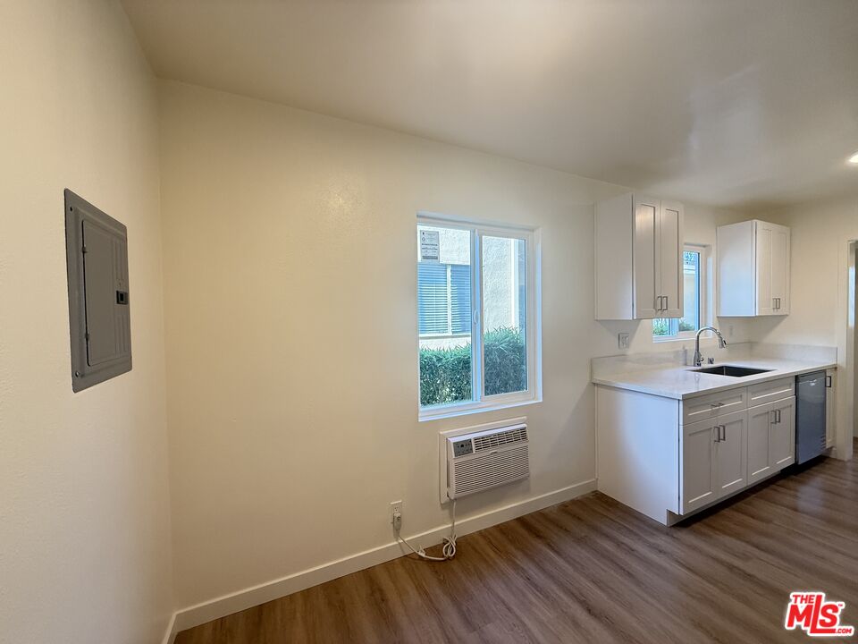 1314 10th Street, Unit A Santa Monica, CA 90401 - Photo 23 of 53 a room with a wooden floor and white walls