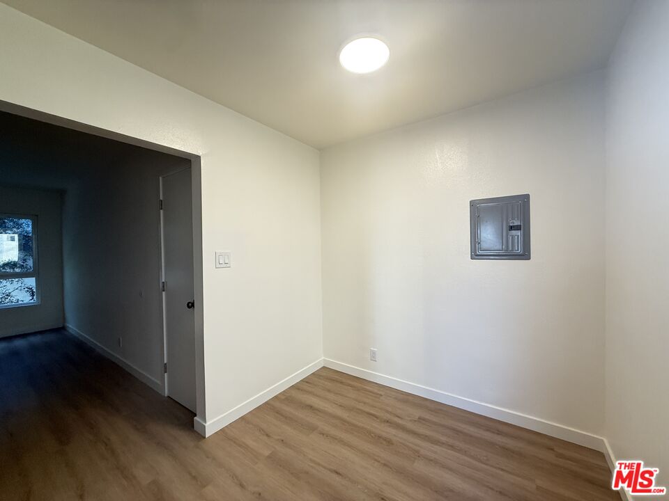 1314 10th Street, Unit A Santa Monica, CA 90401 - Photo 25 of 53 an empty room with wooden floor and windows