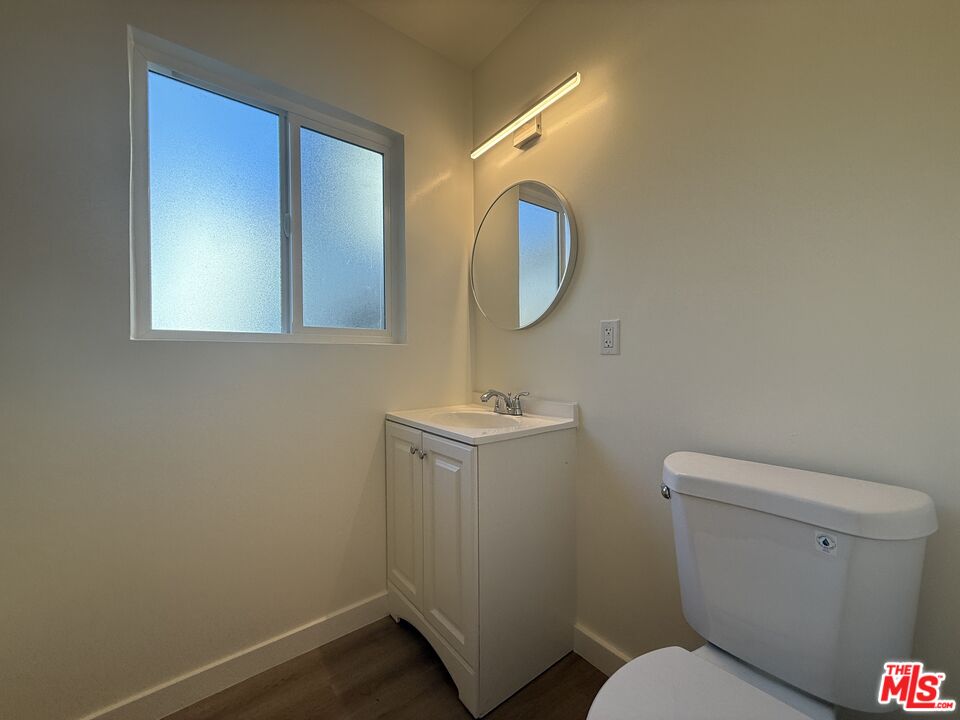 1314 10th Street, Unit A Santa Monica, CA 90401 - Photo 27 of 53 a bathroom with a toilet sink and mirror