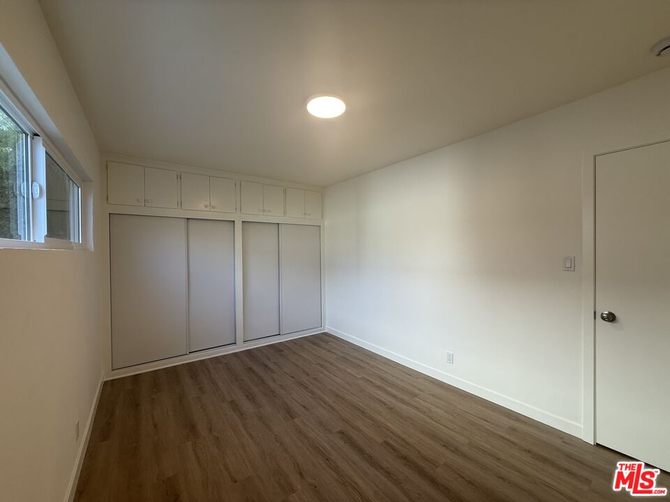 1314 10th Street, Unit A Santa Monica, CA 90401 - Photo 31 of 53 a view of an empty room with wooden floor and a window