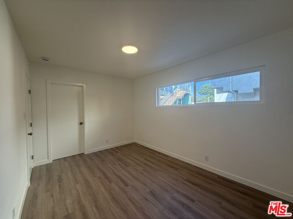 1314 10th Street, Unit A Santa Monica, CA 90401 - Photo 37 of 53 a view of room with window and hardwood floor