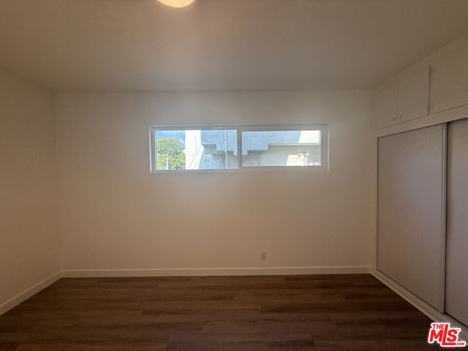 1314 10th Street, Unit A Santa Monica, CA 90401 - Photo 39 of 53 a view of an empty room with wooden floor and a window