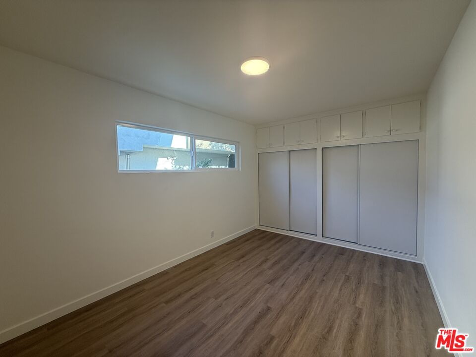 1314 10th Street, Unit A Santa Monica, CA 90401 - Photo 40 of 53 an empty room with wooden floor and windows
