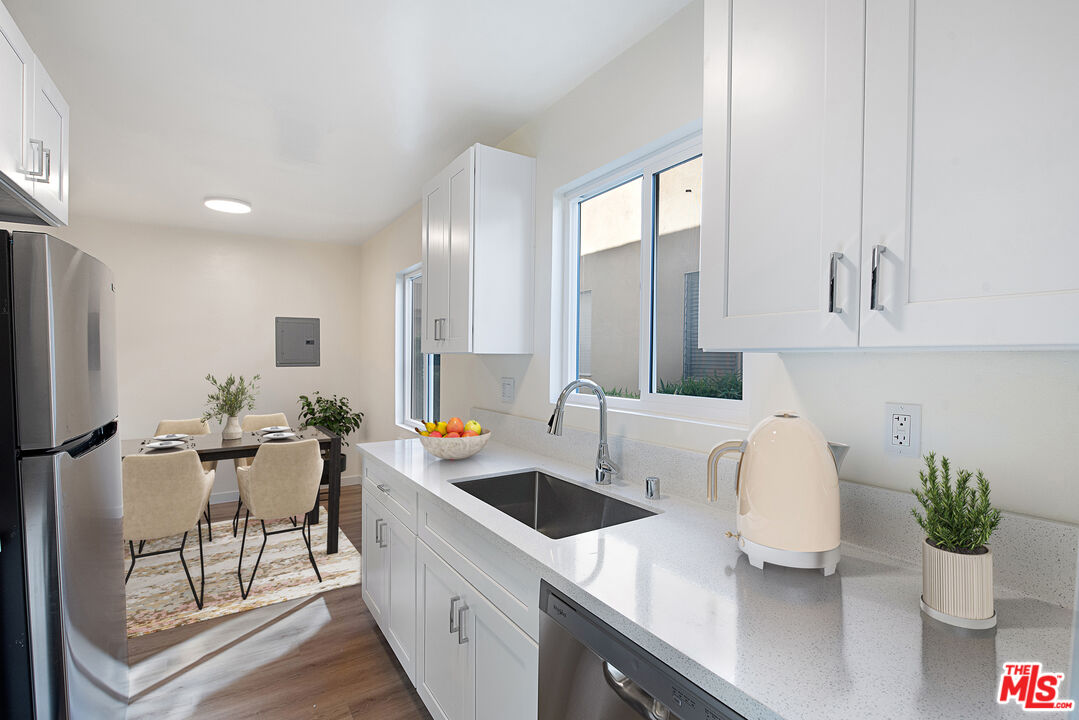 1314 10th Street, Unit A Santa Monica, CA 90401 - Photo 4 of 53 a kitchen with a sink a counter space and appliances