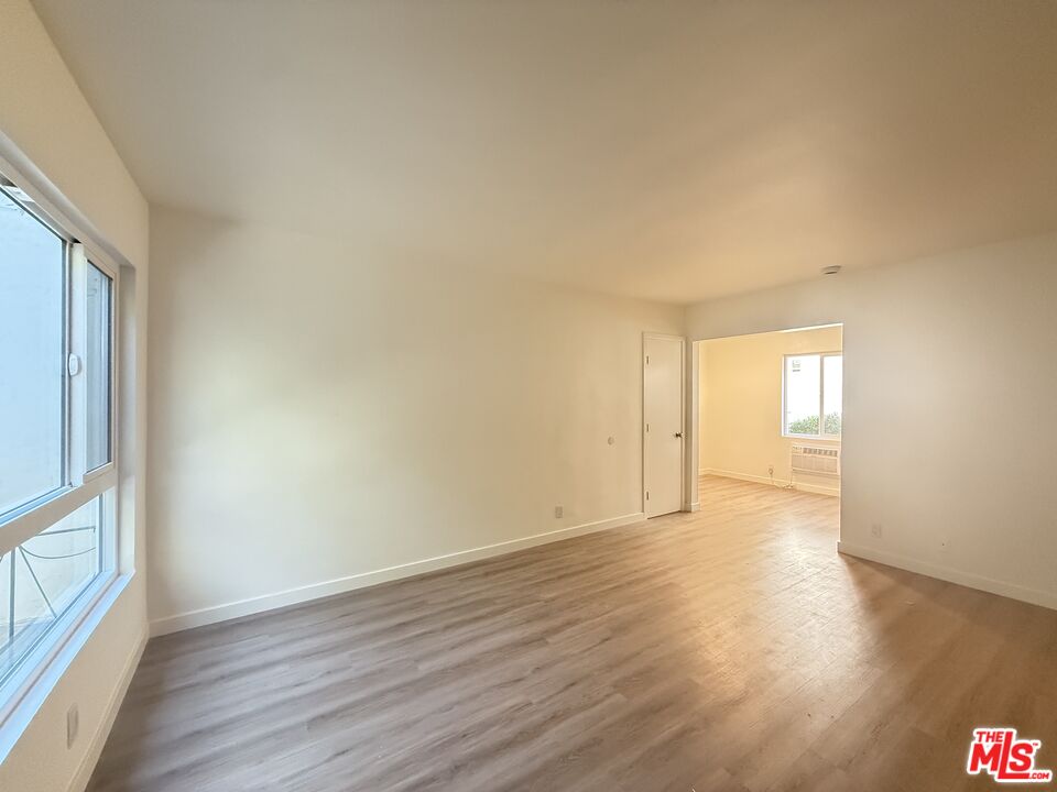 1314 10th Street, Unit A Santa Monica, CA 90401 - Photo 41 of 53 a view of an empty room with wooden floor and a window