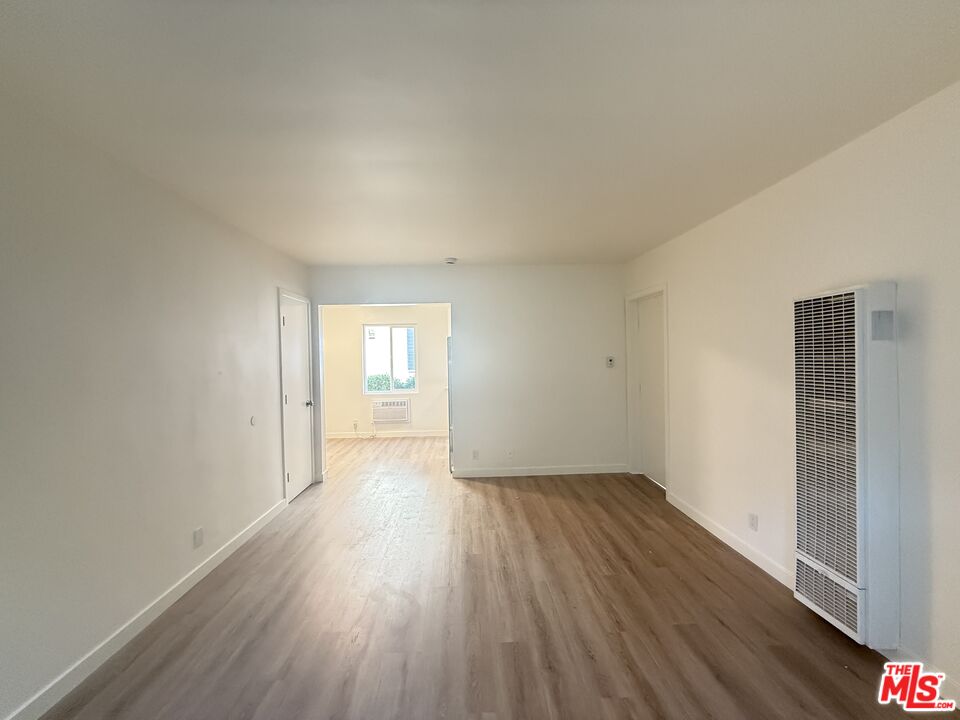 1314 10th Street, Unit A Santa Monica, CA 90401 - Photo 42 of 53 an empty room with wooden floor and windows