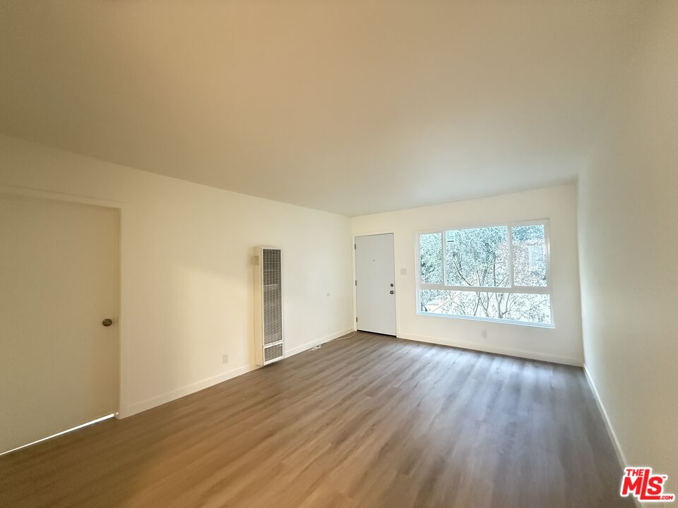 1314 10th Street, Unit A Santa Monica, CA 90401 - Photo 45 of 53 an empty room with wooden floor and windows