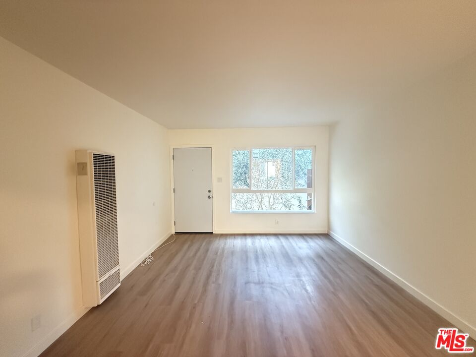 1314 10th Street, Unit A Santa Monica, CA 90401 - Photo 46 of 53 an empty room with wooden floor and windows