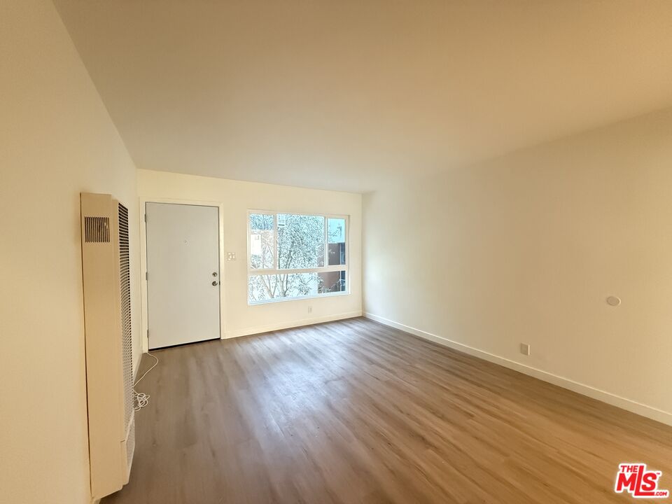 1314 10th Street, Unit A Santa Monica, CA 90401 - Photo 47 of 53 an empty room with wooden floor and windows