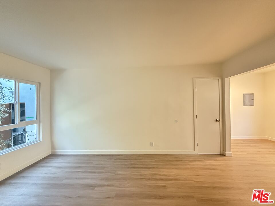 1314 10th Street, Unit A Santa Monica, CA 90401 - Photo 49 of 53 a view of an empty room with wooden floor and a window