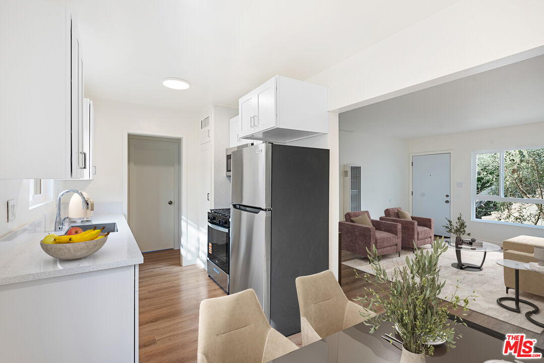 1314 10th Street, Unit A Santa Monica, CA 90401 - Photo 5 of 53 a kitchen with stainless steel appliances granite countertop a refrigerator and a sink