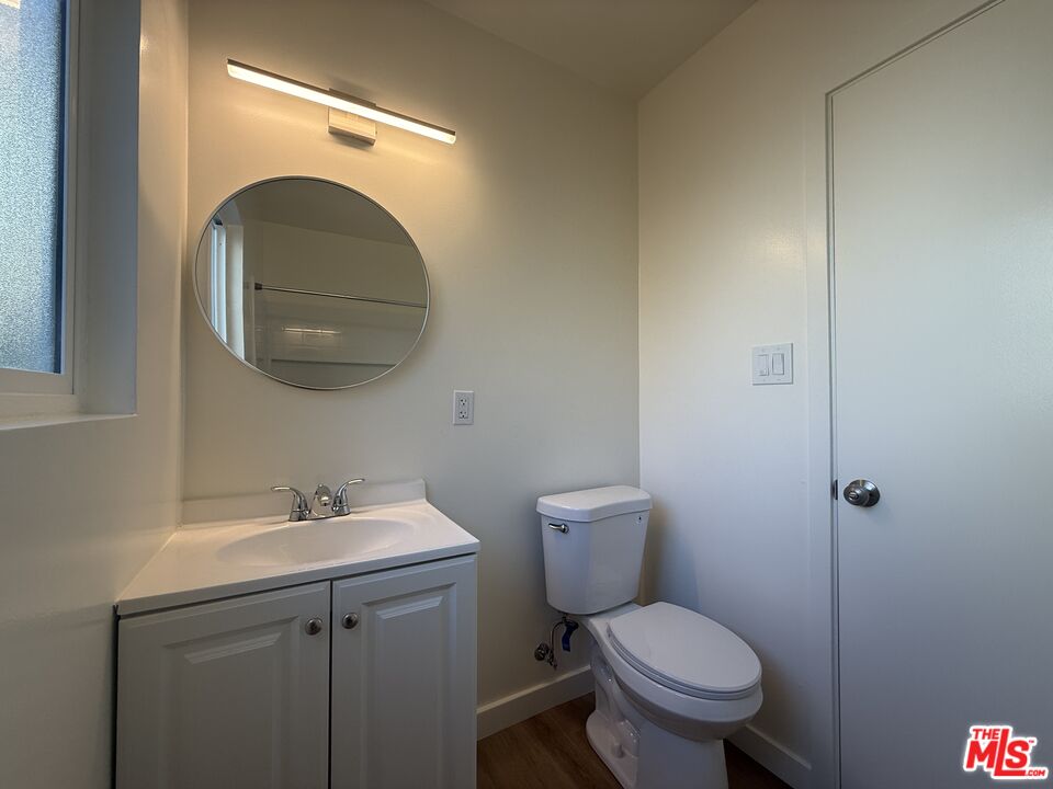 1314 10th Street, Unit A Santa Monica, CA 90401 - Photo 51 of 53 a bathroom with a toilet sink and mirror