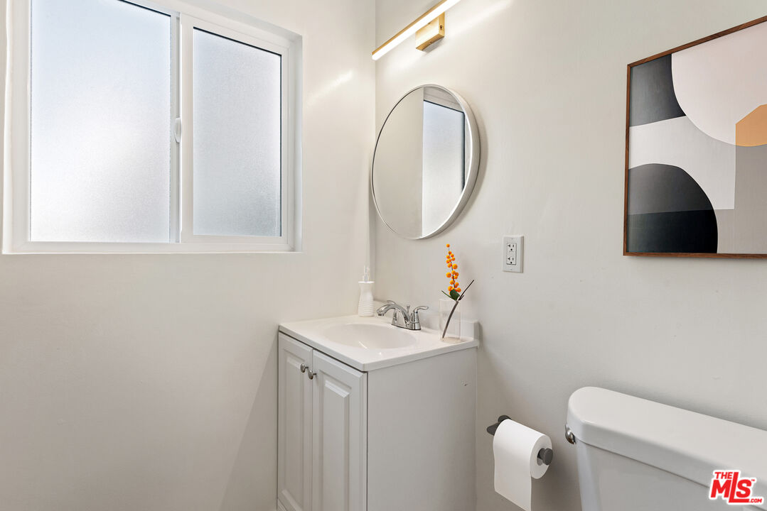 1314 10th Street, Unit A Santa Monica, CA 90401 - Photo 7 of 53 a bathroom with a sink toilet and a mirror