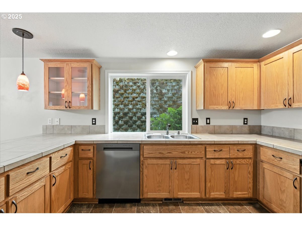 3044 South 3rd Way Ridgefield, WA 98642 - Photo 13 of 34 a kitchen with a sink window and cabinets