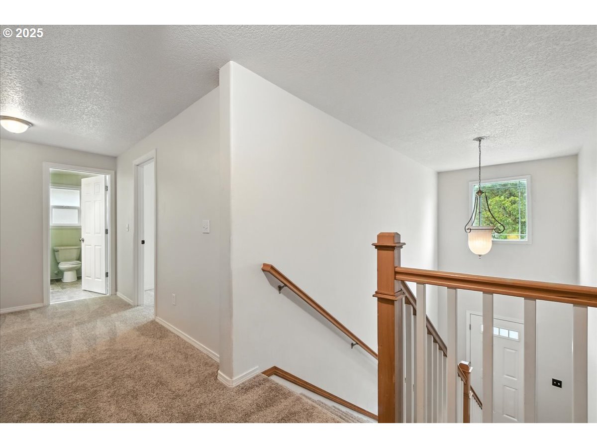 3044 South 3rd Way Ridgefield, WA 98642 - Photo 17 of 34 a view of a hallway with wooden floor and stairs