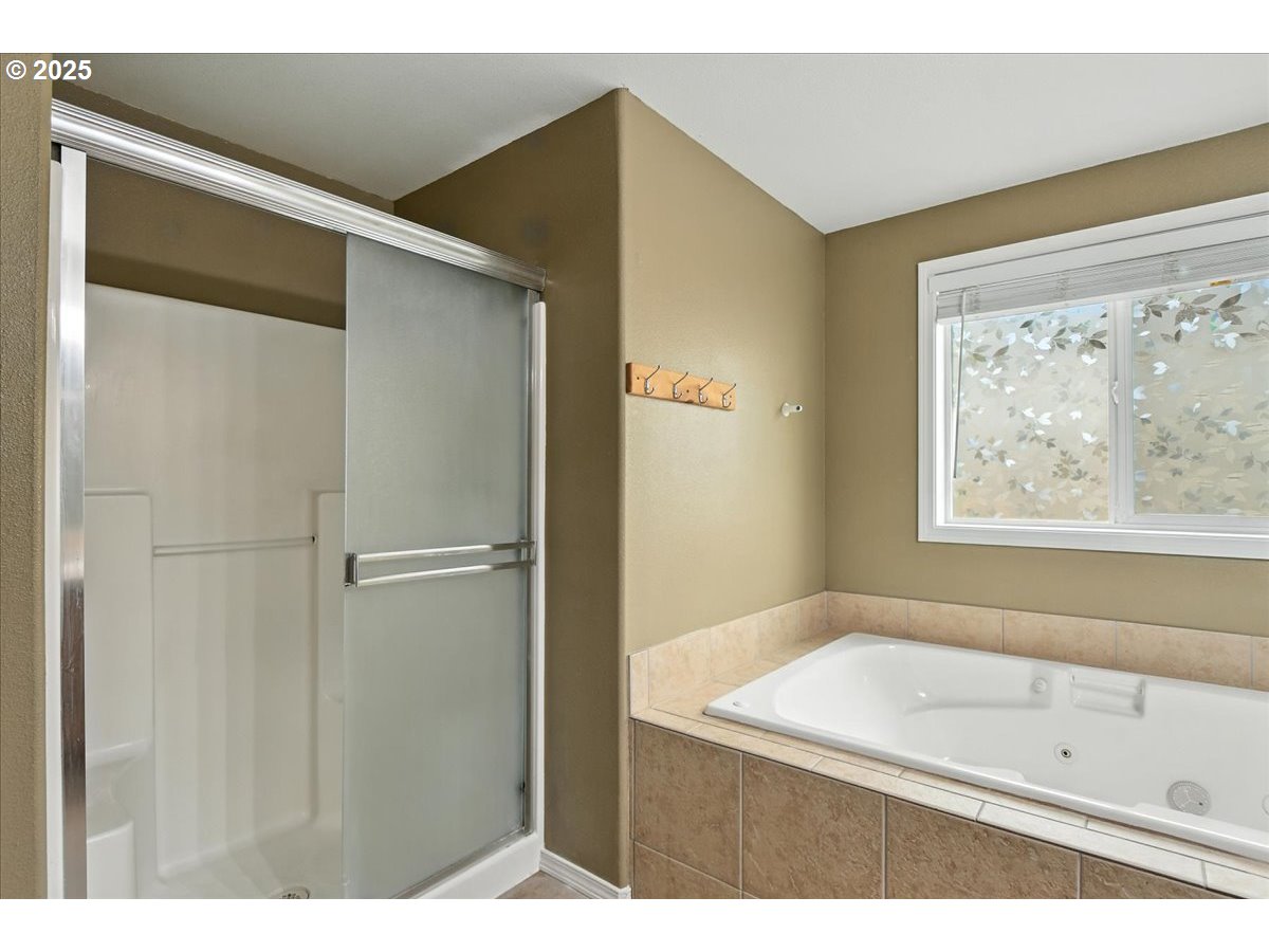 3044 South 3rd Way Ridgefield, WA 98642 - Photo 22 of 34 a bathroom with a bathtub and a shower