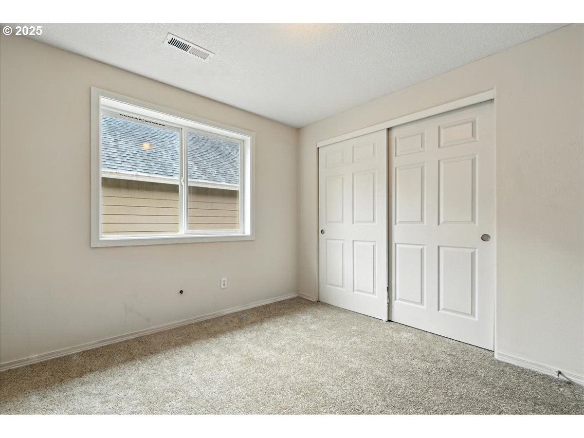3044 South 3rd Way Ridgefield, WA 98642 - Photo 24 of 34 an empty room with wooden floor and windows