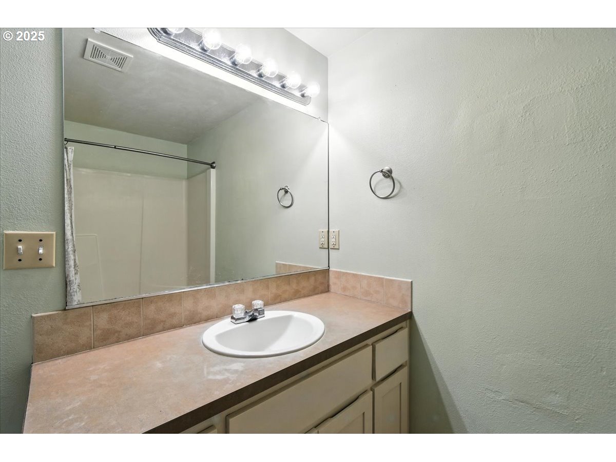 3044 South 3rd Way Ridgefield, WA 98642 - Photo 28 of 34 a bathroom with a sink and a mirror