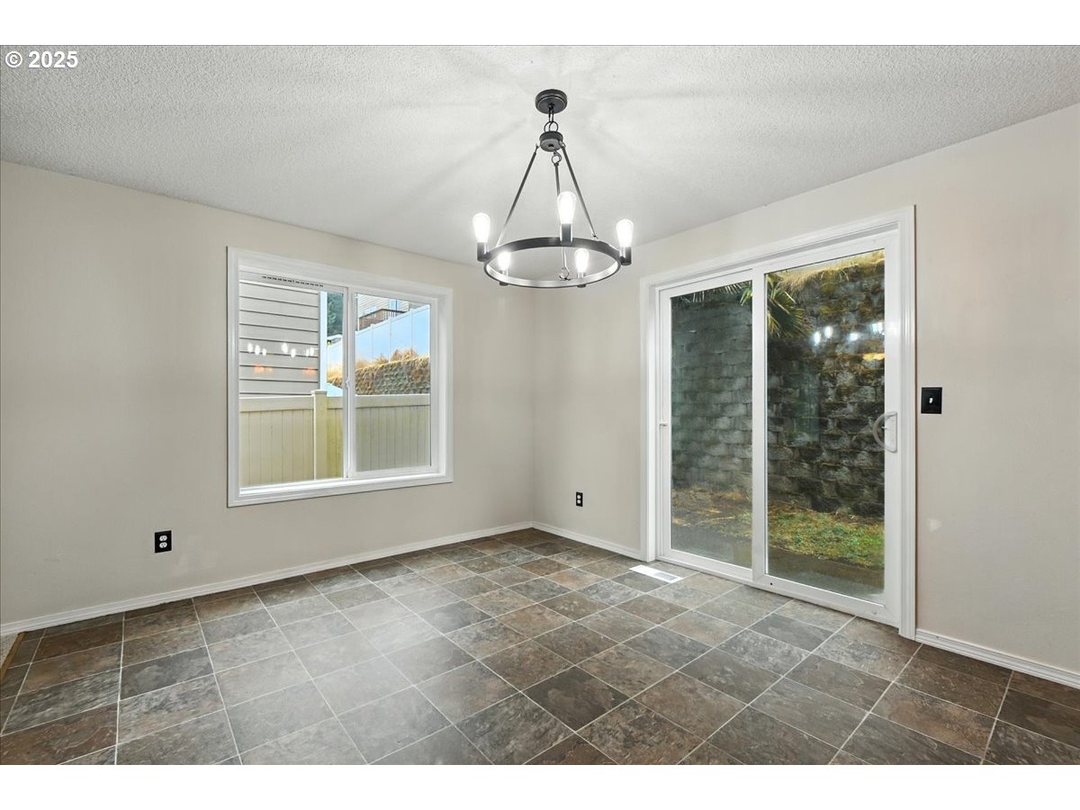 3044 South 3rd Way Ridgefield, WA 98642 - Photo 10 of 34 a view of an empty room with wooden floor and a window