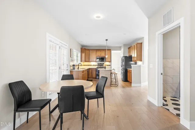 a spacious bedroom with a bed and wooden floor