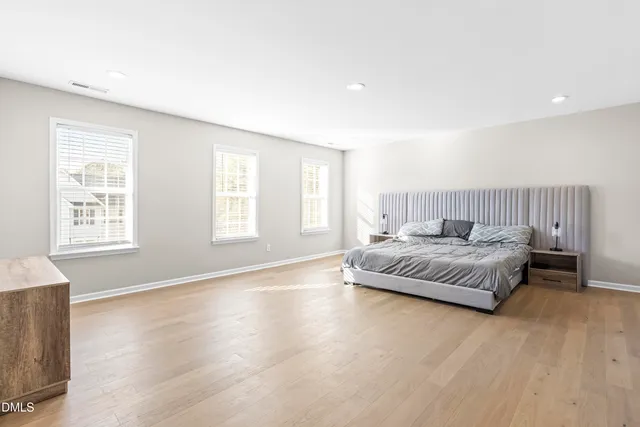 a bathroom with a double vanity sink toilet mirror and shower